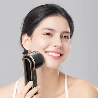 a woman holding a hair dryer in her hand