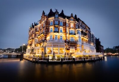 A beautiful, illuminated building stands on the water.